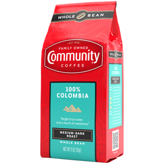 An eleven-ounce bag of whole bean Community Coffee One Hundred Percent Colombia medium-dark roast, rotated a quarter-turn to the left.