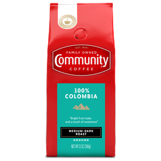 A twelve-ounce bag of ground Community Coffee One Hundred Percent Colombia medium-dark roast, shown from the front.