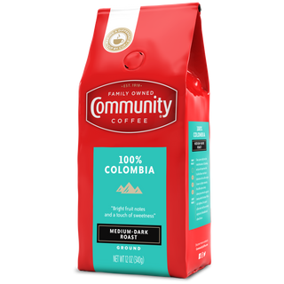 A twelve-ounce bag of ground Community Coffee One Hundred Percent Colombia medium-dark roast, rotated a quarter-turn to the left.