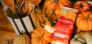 A lifestyle image of a bag ground Spiced Pumpkin Pecan Pie in an Autumn setting
