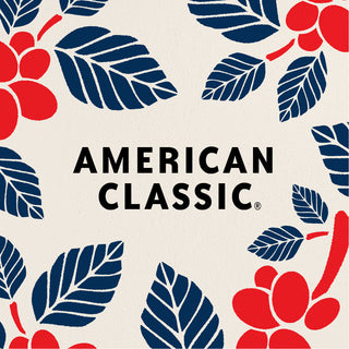 A graphic design reading AMERICAN CLASSIC, surrounded by illustrations of red-and-blue coffee plants on a cream background.