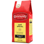 A twelve-ounce bag of ground Community Coffee Café Special medium-dark roast, rotated a quarter-turn to the left.
