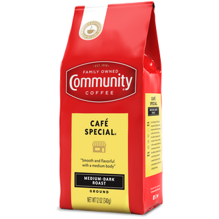 A twelve-ounce bag of ground Community Coffee Café Special medium-dark roast, rotated a quarter-turn to the left.
