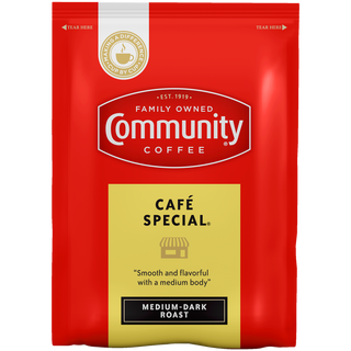 A two-point-five-ounce packet of ground Community Coffee Café Special medium-dark roast, shown from the front.