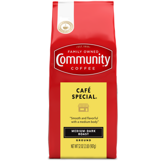 A thirty-two-ounce bag of ground Community Coffee Café Special medium-dark roast, shown from the front.