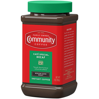 A seven-ounce jar of instant Community Coffee Café Special Decaf medium-dark roast, rotated a quarter-turn to the left.