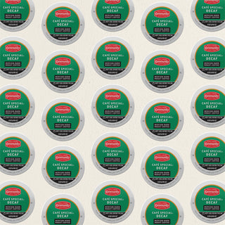 Rows of K-Cup lids for Community Coffee Café Special Decaf medium-dark roast lie flat against a white background.