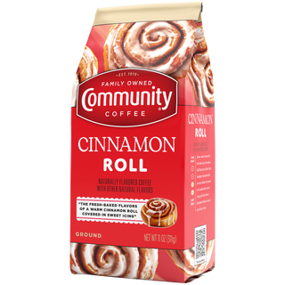 An eleven-ounce bag of ground Community Coffee Cinnamon Roll flavored coffee, rotated a quarter-turn to the left.