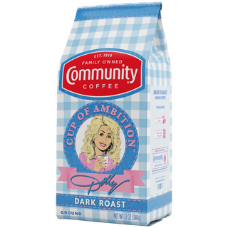 A twelve-ounce bag of Cup of Ambition Dark Roast ground coffee, crafted in partnership between Dolly Parton and Community Coffee, rotated a quarter-turn to the left.