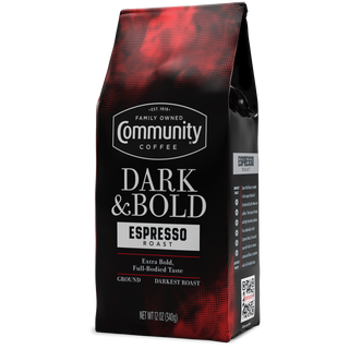 A twelve-ounce bag of ground Community Coffee Dark & Bold Espresso Roast, rotated a quarter-turn to the left.