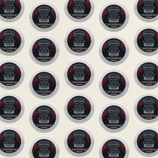 Rows of K-Cup lids for Community Coffee Dark and Bold Espresso Roast lie flat against a white background.