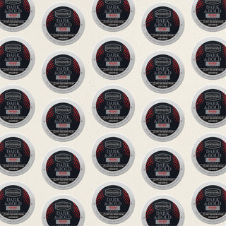 Rows of K-Cup lids for Community Coffee Dark and Bold Intense Blend lie flat against a white background.
