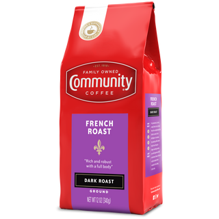 A twelve-ounce bag of ground Community Coffee French Roast dark roast, rotated a quarter-turn to the left.
