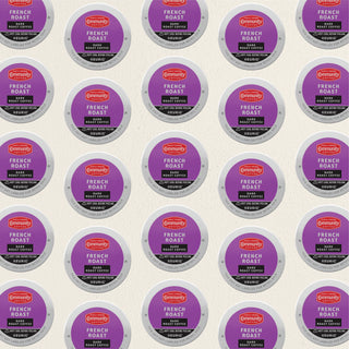 Rows of K-Cup lids for Community Coffee French Roast dark roast lie flat against a white background.