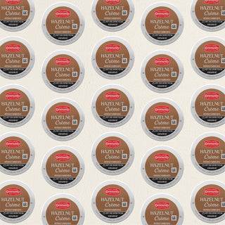 Rows of K-Cup lids for Community Coffee Hazelnut Crème flavored coffee lie flat against a white background.