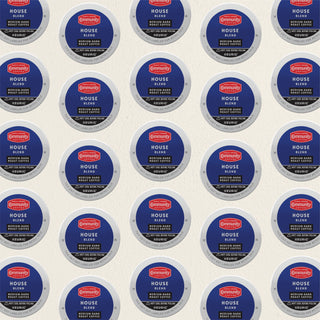 Rows of K-Cup lids for Community Coffee House Blend medium-dark roast lie flat against a white background.
