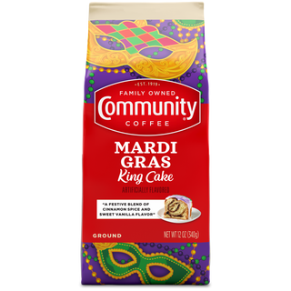 A twelve-ounce bag of ground Community Coffee Mardi Gras King Cake flavored coffee, shown from the front.