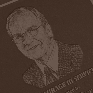 A service award plaque showing the likeness of third-generation Community Coffee owner Norman Saurage the Third.