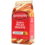 A twelve-ounce bag of ground Community Coffee Southern Pecan Praline flavored coffee, rotated a quarter-turn to the left.