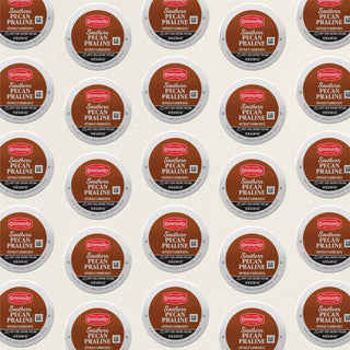 Rows of K-Cup lids for Community Coffee Southern Pecan Praline flavored coffee lie flat against a white background.