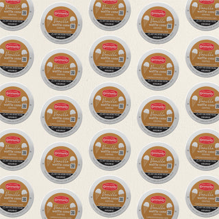 Rows of K-Cup lids for Community Coffee Vanilla Waffle Cone flavored coffee lie flat against a white background.